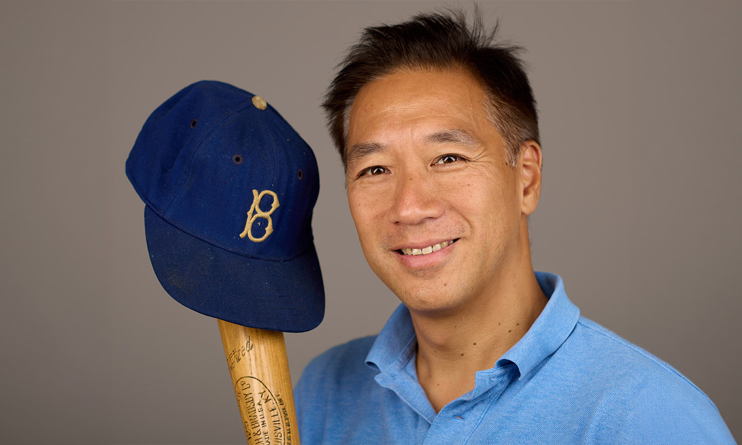 Stephen Wong '89 poses for a portrait with his baseball memorabilia.