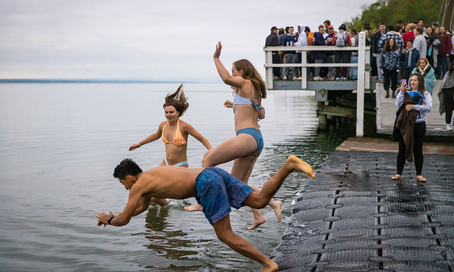 As is tradition on the day of Commencement, after watching the sunrise from Bozzuto Boathouse, HWS graduates jump into Seneca Lake.