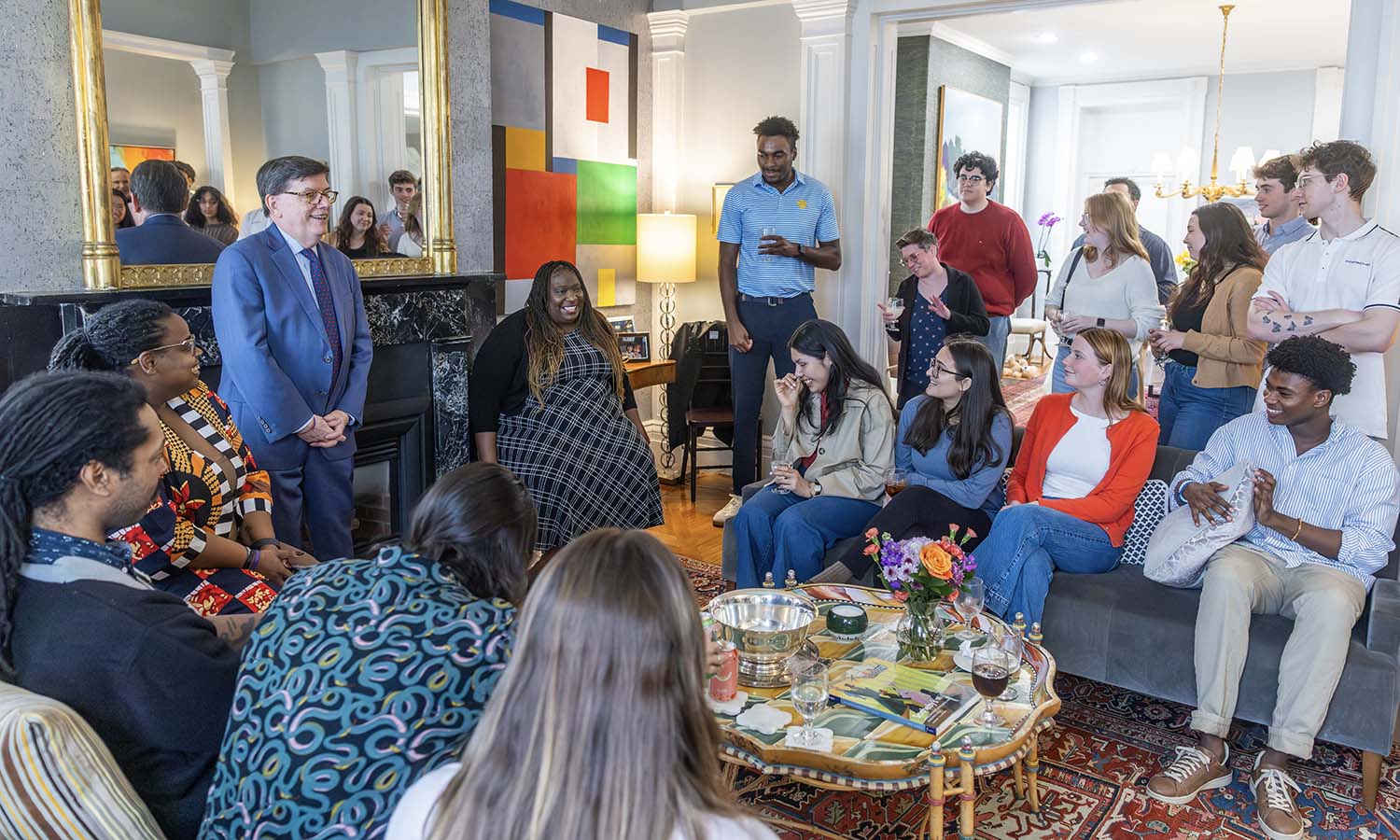 Maya Rupert joins faculty, staff and students at President Mark D. Gearan's home.&nbsp;