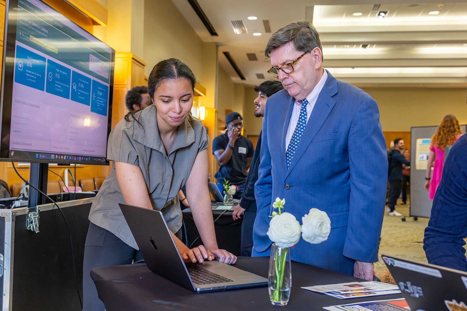 President Mark D. Gearan visits with student presenters. 