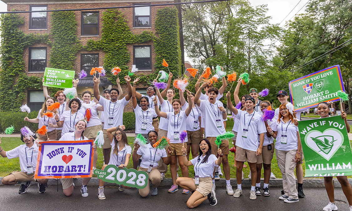 group cheering with pom poms and signs