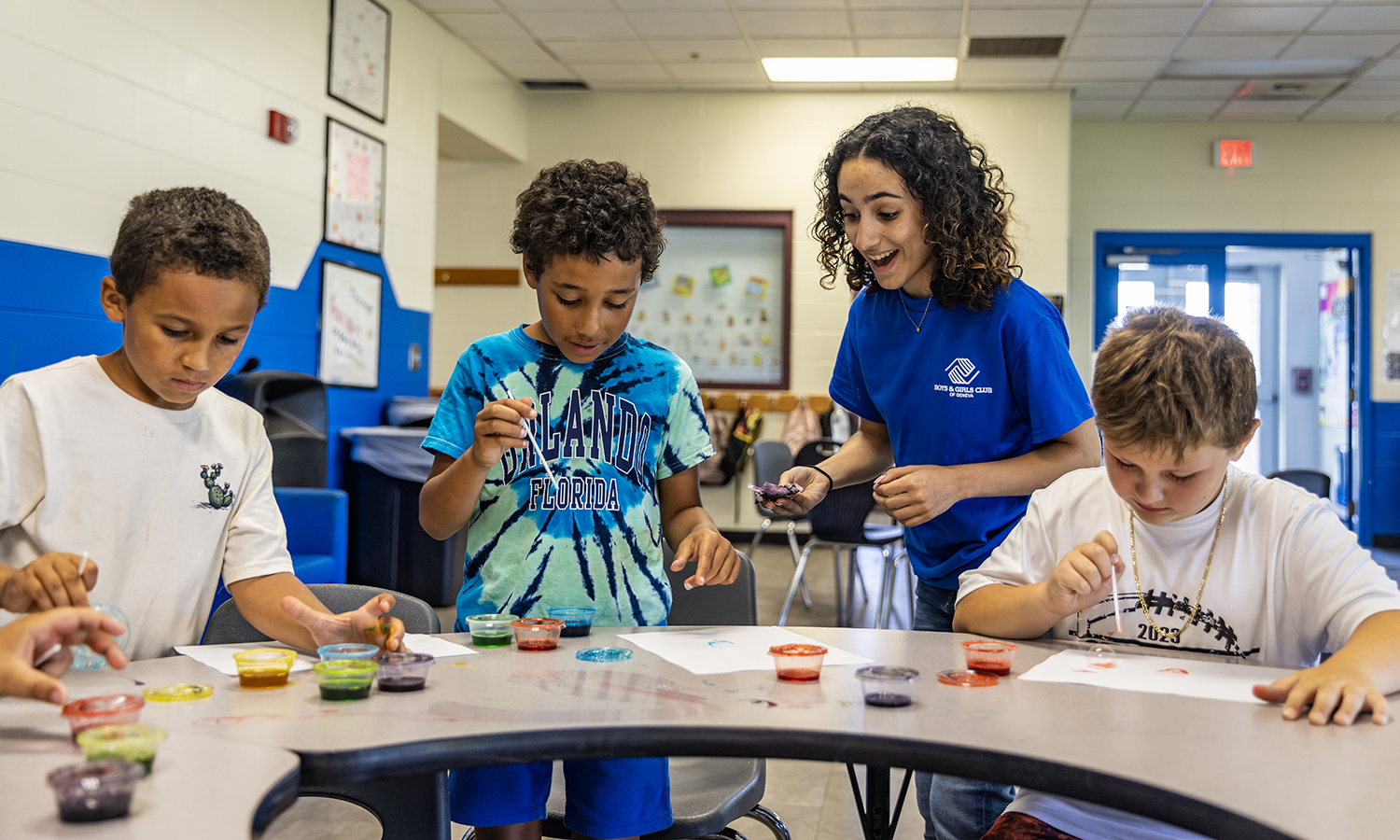 hws tutor works with young kids at crafts table