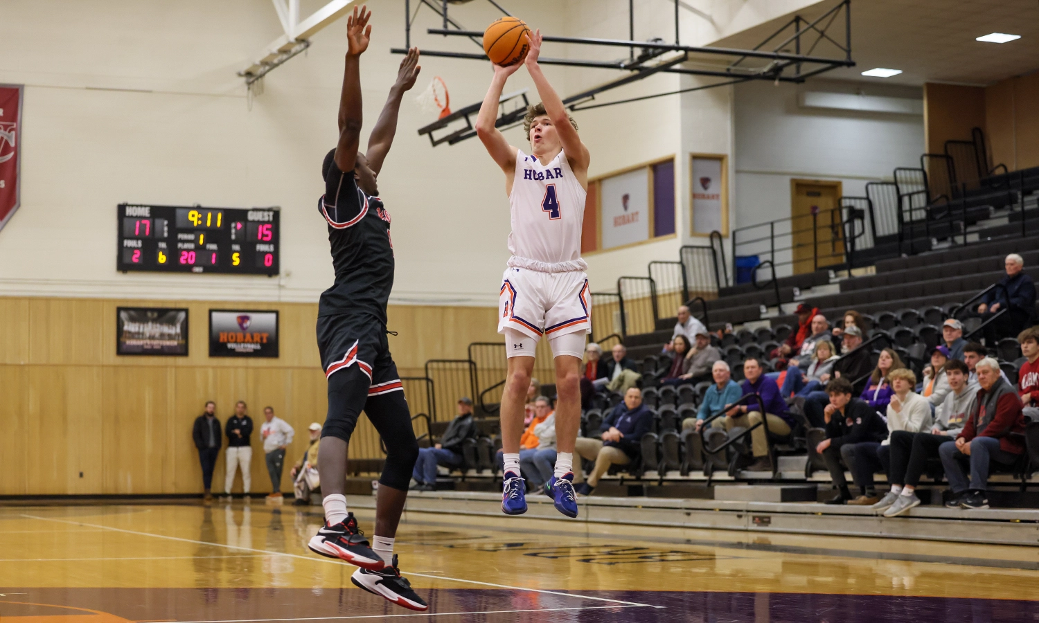 Alex Moesch ’27 launches a jumper over a Wells defender. He finished the contest with a game-high 18 points as the Hobart basketball team improved to 8-0 on the season.