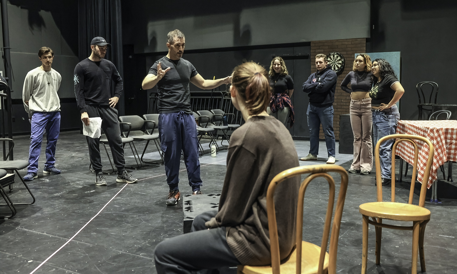 Associate Professor of Theatre Chris Hatch leads students during rehearsal for “Much Ado About Nothing” in the McDonald Theatre.
