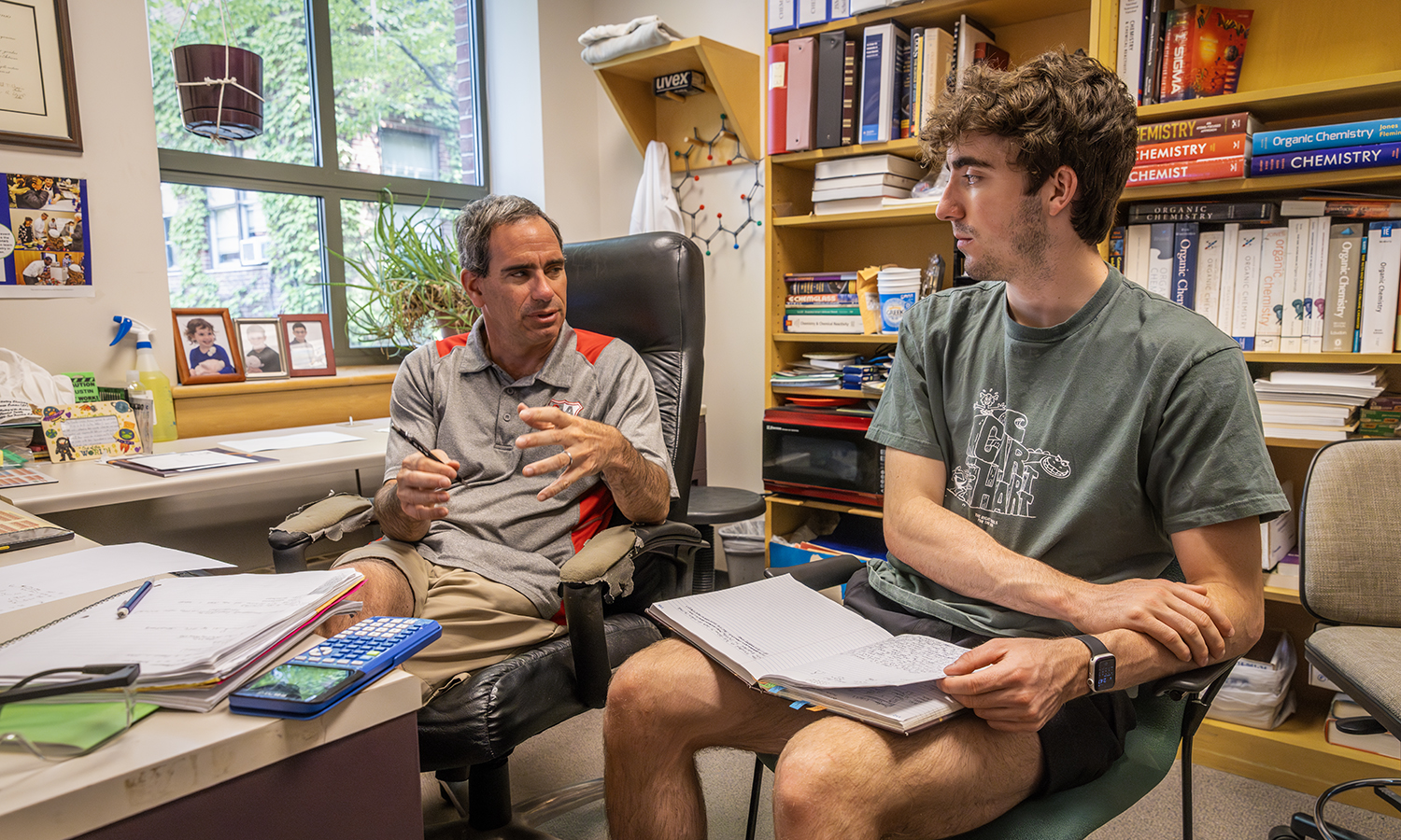 Professor of Chemistry Justin Miller and Brogan Dietsche ’25 discuss the nuclear magnetic resonance data from the research project that they are working on this summer.