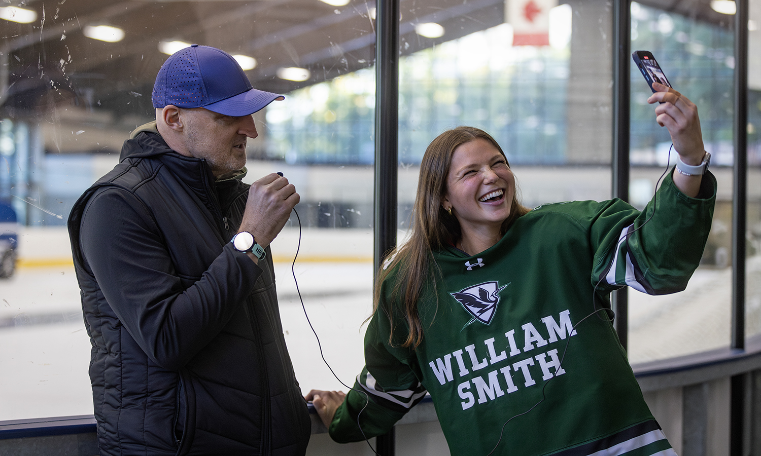 Kayla Ketchabaw ’25 interviews William Smith Ice Hockey Head Coach Matthew Cunningham for a TikTok interview during the Heron’s Media Day.