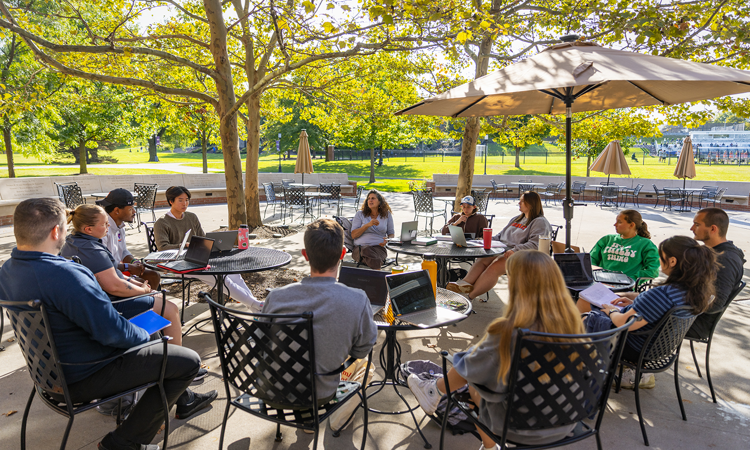 On the patio of the Scandling Campus Center, Associate Provost Susan Pliner leads a discussion in “History of Disability” for students in the Master’s of Higher Education Leadership program.
