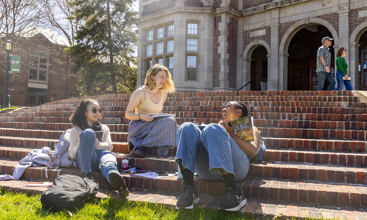 Maria Galarza ’26, Elizabeth Legg ’26 and Faith Okoli ’26 share a laugh while studying on the steps of Coxe Hall.