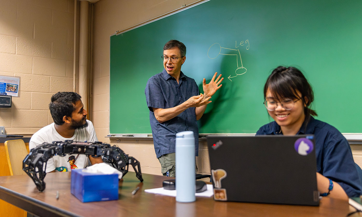 Khairul Islam ’25, Assistant Professor of Mathematics and Computer Science Chris Fietkiewicz and Linh Tran ’26 collaborate on a summer research project in robotics.