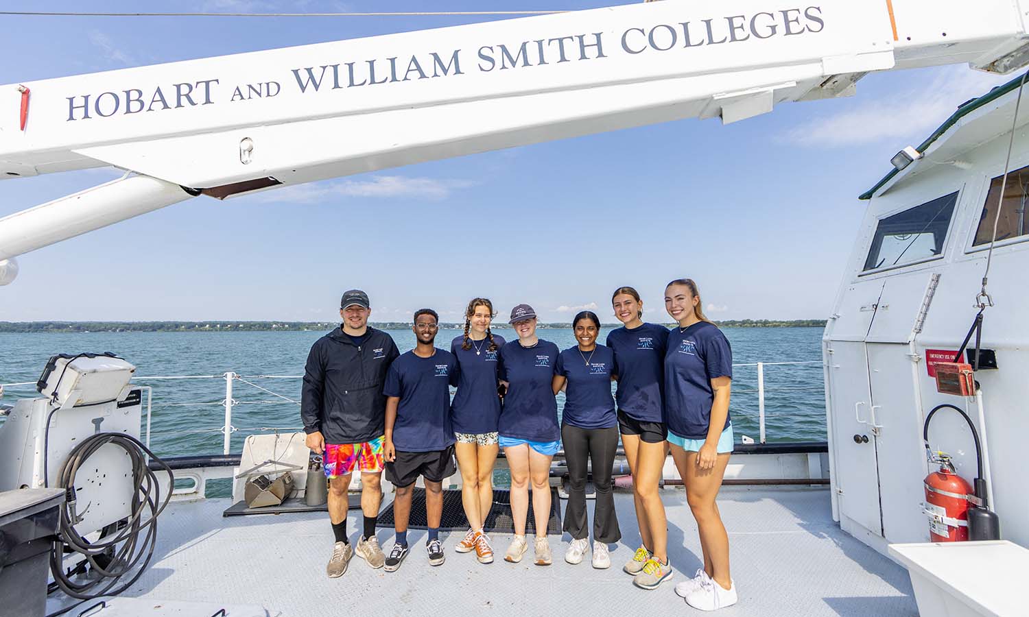 This week, we take a look at the research HWS students are conducting working with HWS’ Finger Lakes Institute this summer. Here, FLI Lab Manager Trevor Massey, Daudi Aden ’26, Ingrid Miller ’26, Caroline Gannon ’26, Anjalee Wanduragala ’25, Isabella Mujevic ’26 and Jaylynn McCarthy ’26 pose for a photo aboard the William Scandling research vessel.