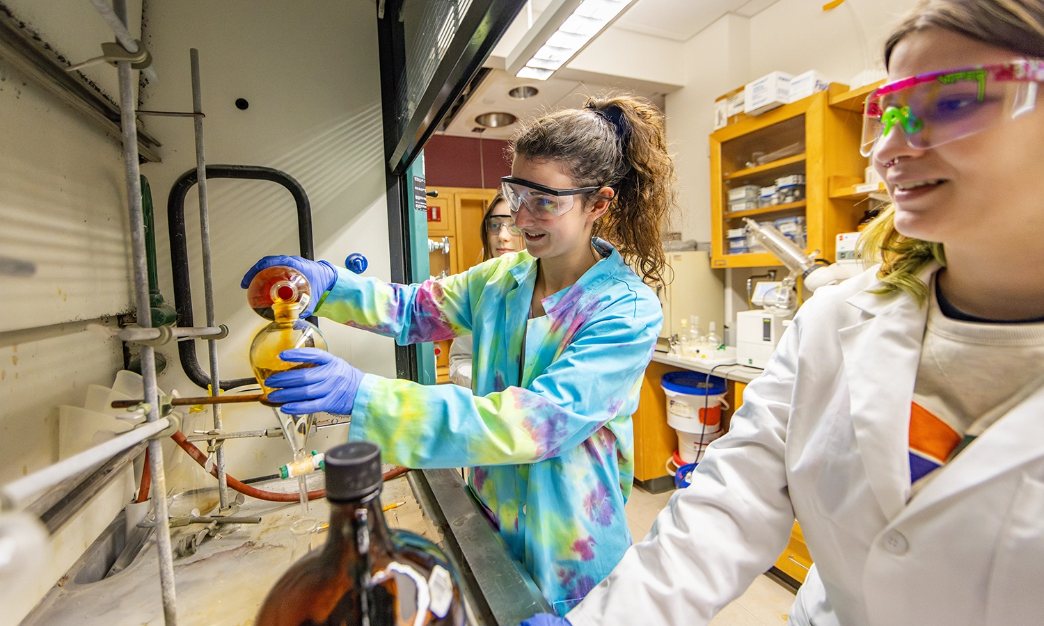 Keira Potvin ’25, Cayden Smith ’24 and Elle Grillo ‘25 create a reaction using a liquid-liquid extraction while conducting research with Professor of Chemistry Erin Pelkey.