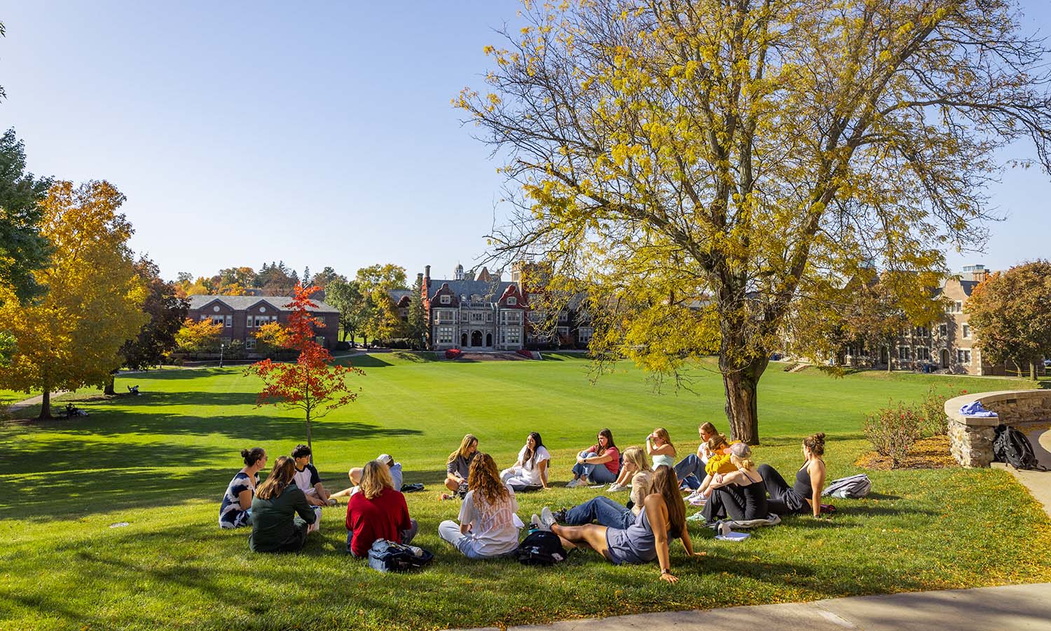 Associate Professor of Educational Studies Diana Baker takes advantage of the beautiful weather to host class on the Quad.