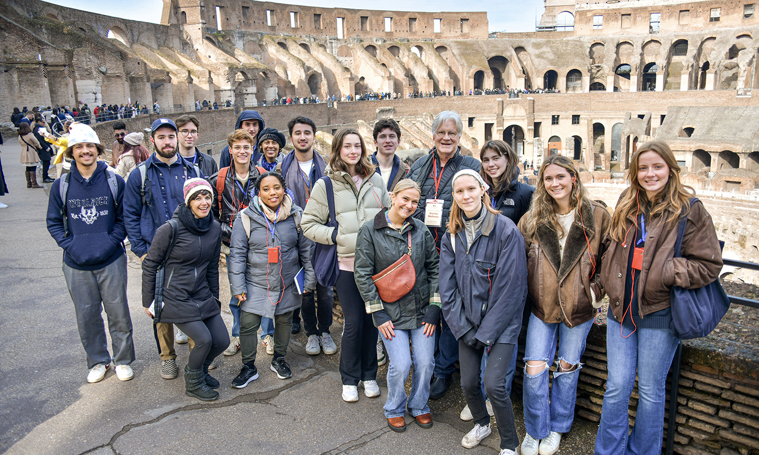 In Rome, Italy, Associate Professor of Art and Architecture Stan Mathews gathers with students at the Roman Colosseum.
