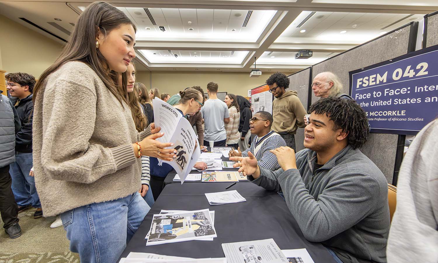 Nehemiah Wagner ’29, Jair Brown ’29 and Hilton Johnson ’29 present the zines they created during “Face to Face: Interrogating Race in the United States & South Africa” with Visiting Associate Professor of Africana Studies James McCorkle ’76, P’20. 