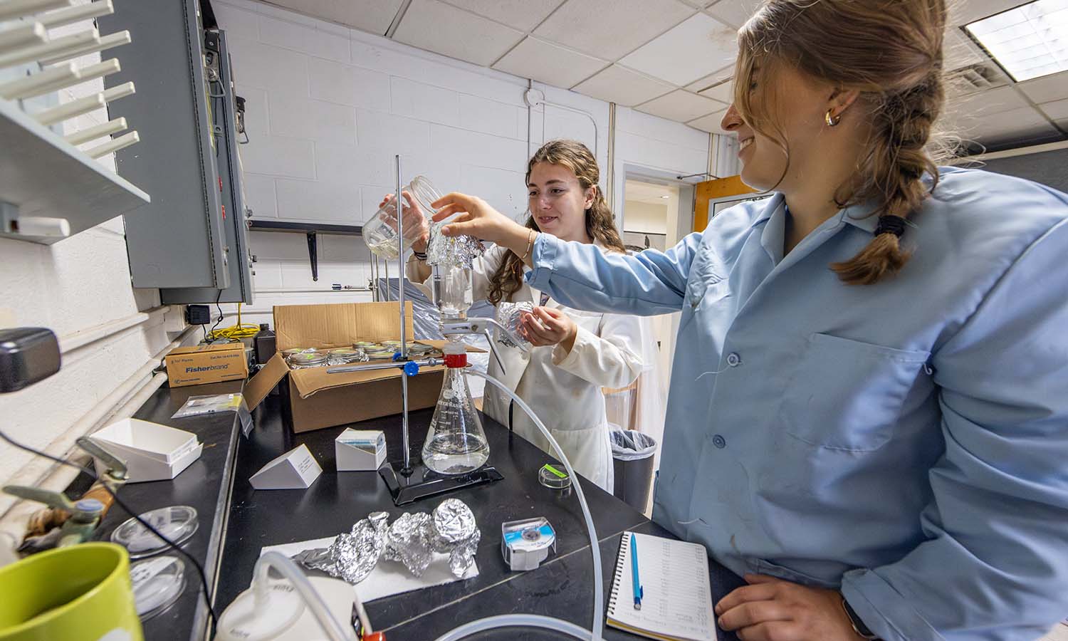 Under the guidance of Professor of Geoscience Nan Crystal Arens, Aubree Klein of St. Olaf College and Delilah Heutsche ’26 filter water sampled from different Finger Lakes to capture and quantify anthropogenic fibers and determine pollution levels. 