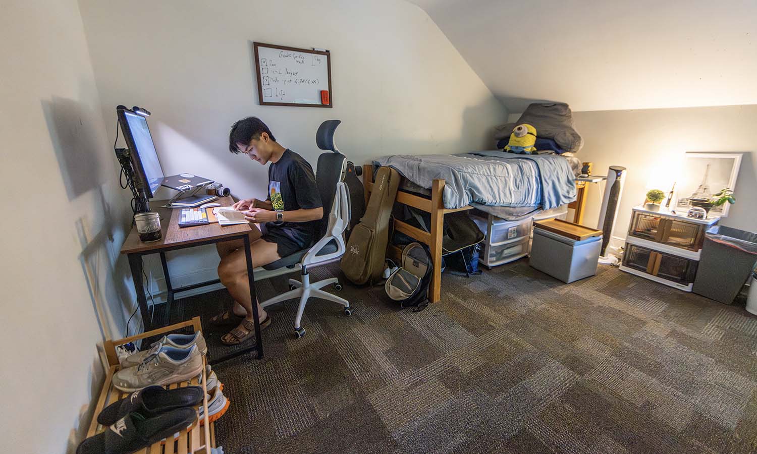 Andy Dinh ’27 works in his McCormick House dorm room, where he is living this summer while working at Bristol Field House. 