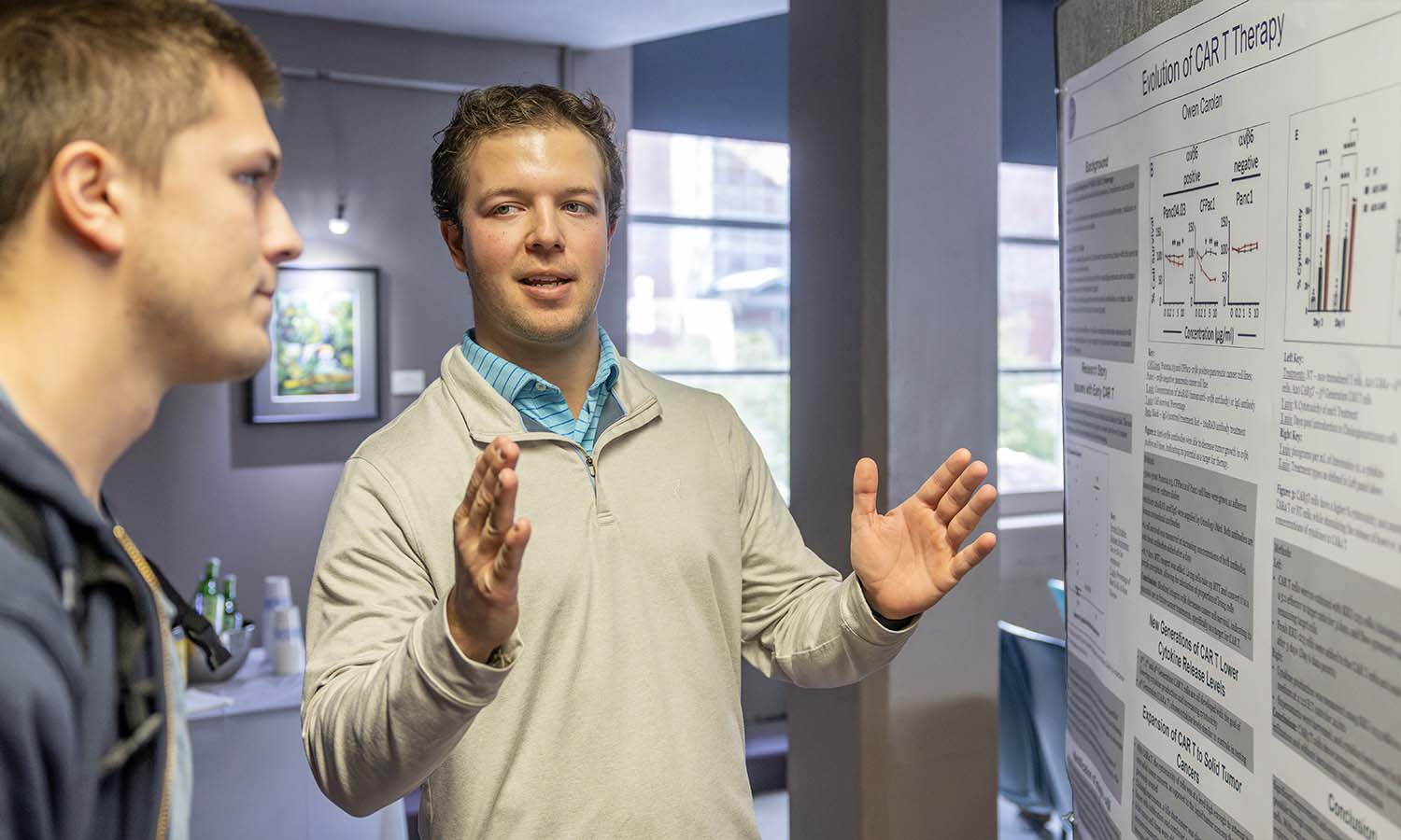 Owen Carolan ’26 presents his project “Evolution of CAR T Therapy” at the Biology department poster presentation event in Albright Auditorium. 
