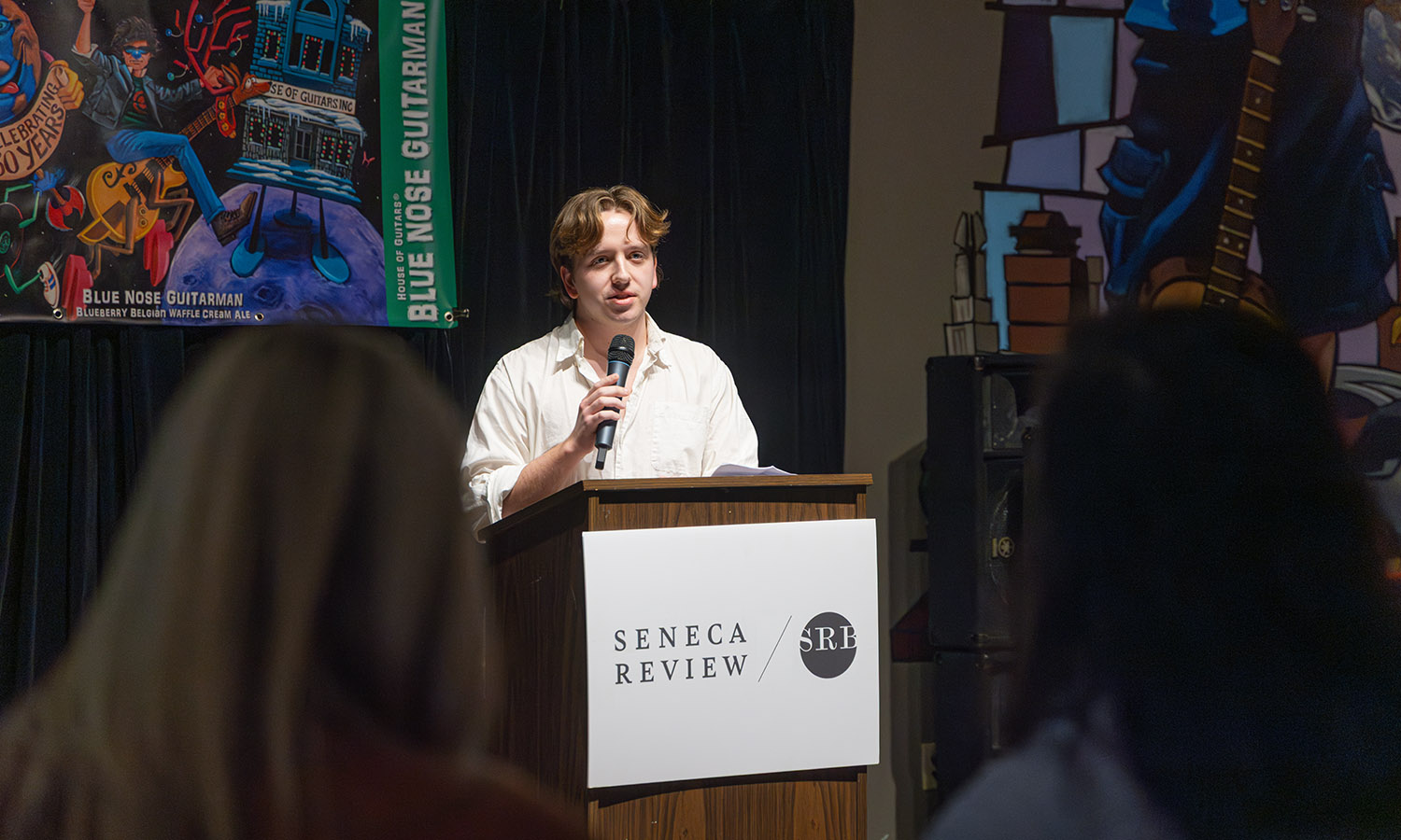 Andrew Pilet '26 shares some of his work during a Seneca Review Poetry Reading at Three Heads Brewing in Rochester. The event also featured Hazel Brown '28, Laura Thérien '26, and Pulitzer Prize winning poet Carl Dennis.  