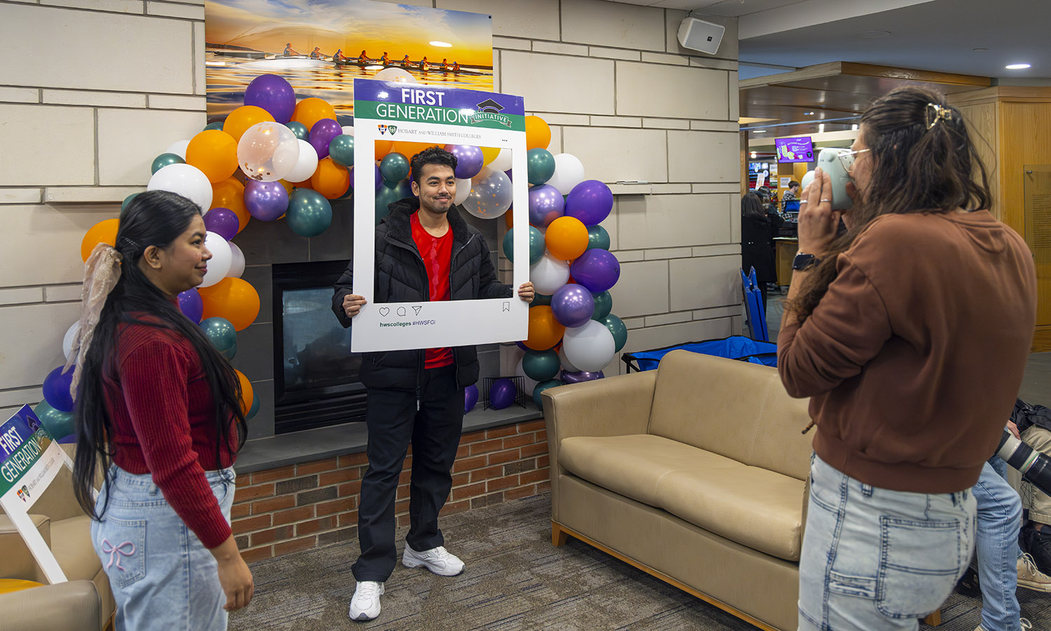 Director of Intercultural Programs and Initiatives Shanelle France '11 takes photos of students in Scandling Student Center celebrating the First Generation Initiative. 