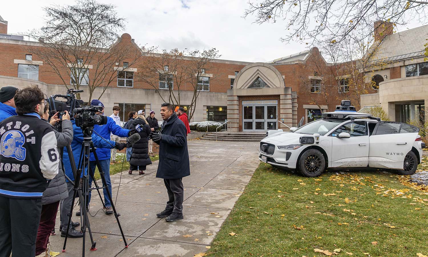 New York State Senator and HWS Trustee Jeremy A. Cooney ’04 (D-56) speaks to the local media about Waymo’s visit to campus. Parked outside the Scandling Campus Center, students explored how artificial intelligence is transforming the way people move. 