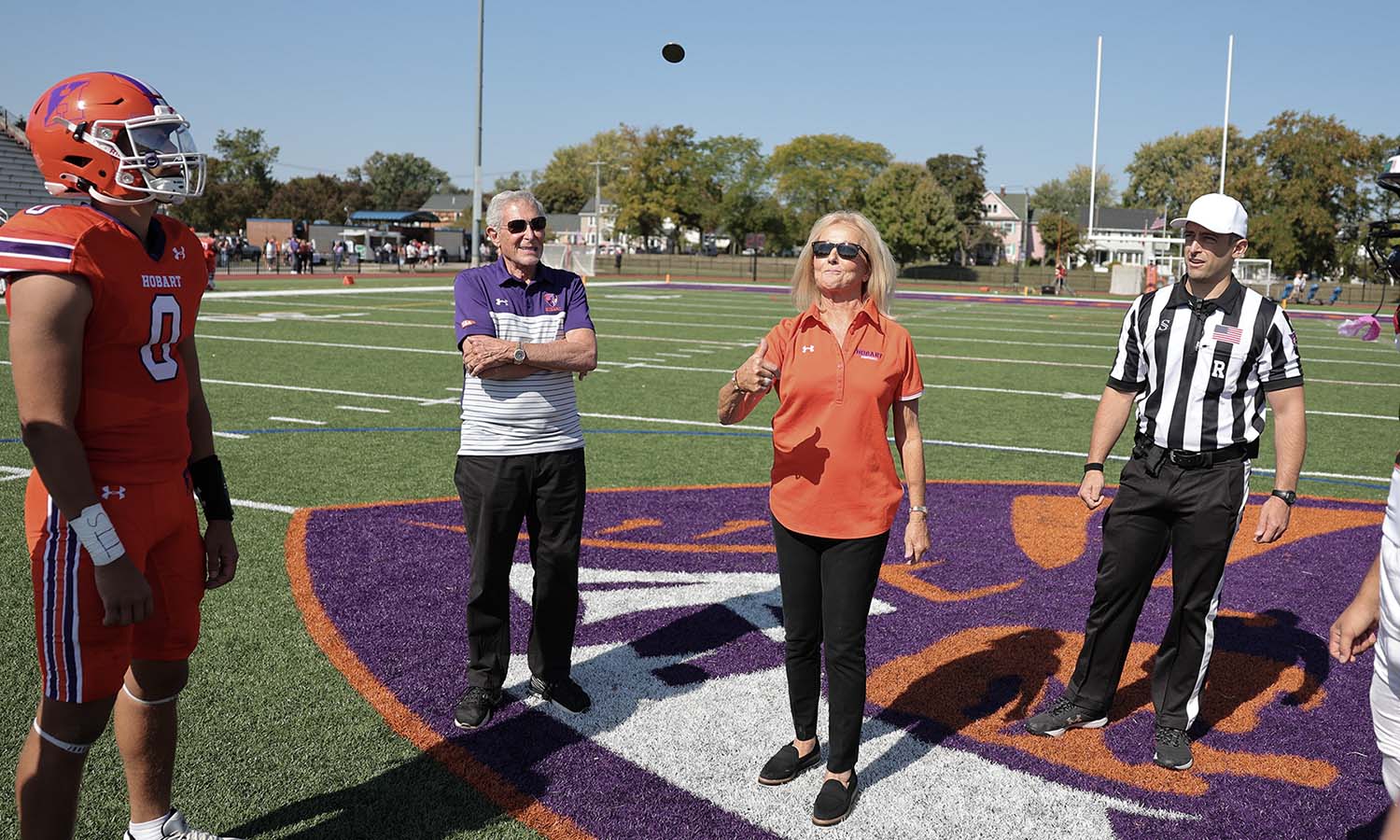 Stanley Gitelson and Cynthia Gitelson L.H.D.’12 perform the coin toss before Hobart football’s game against RPI. 