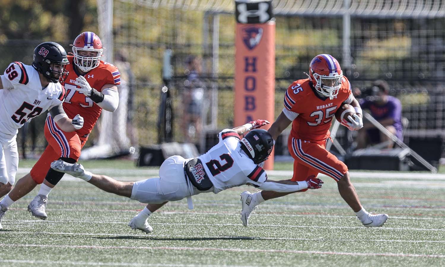 E.J. Taylor ’27 breaks through a tackle against RPI on Saturday at Urick Stadium. 