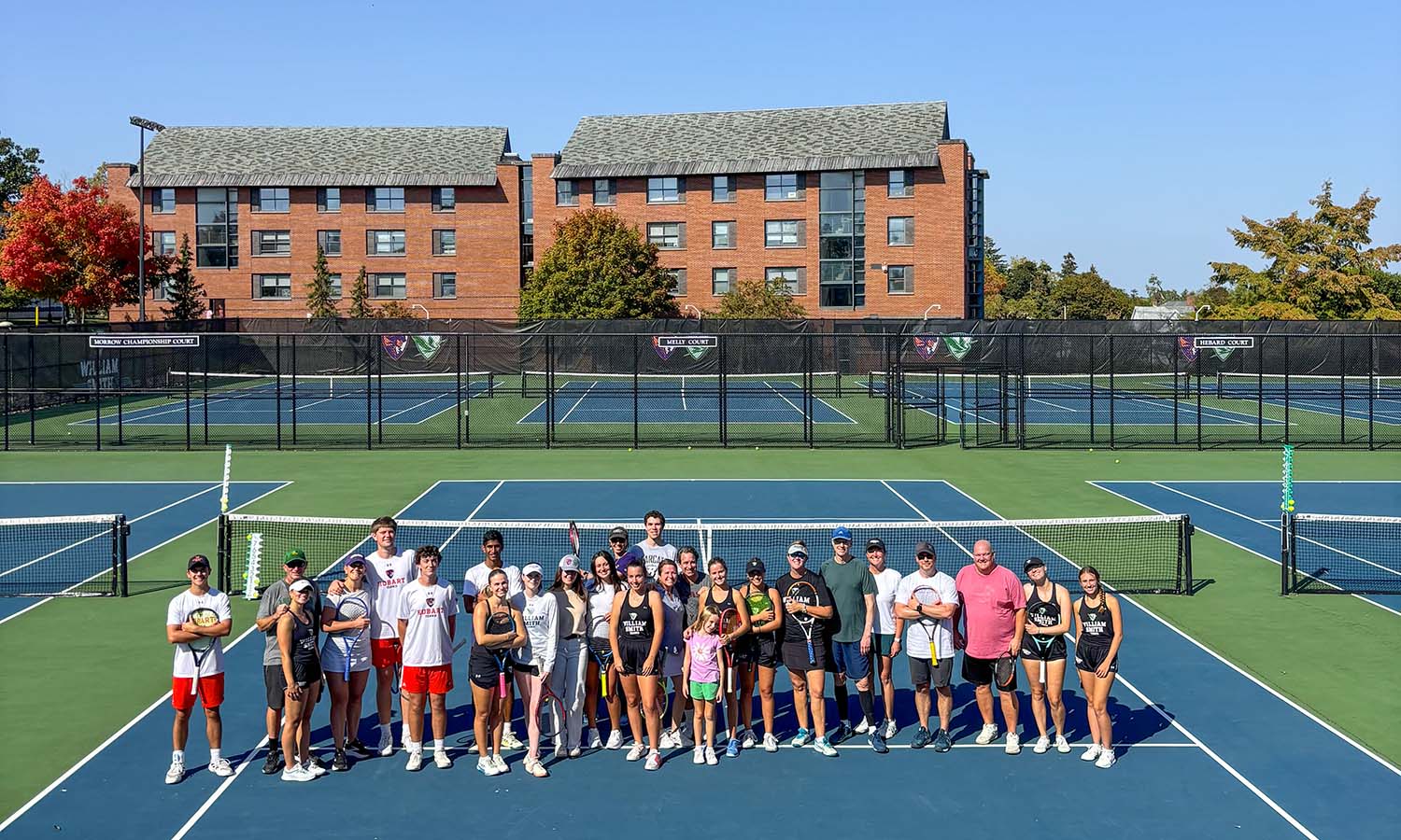 Alumni and members of the HWS tennis teams pose for a photo after competing in the 2nd annual Homecoming and Family Weekend Tennis Tournament. 