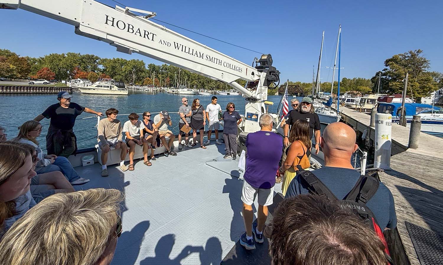 Aboard the William Scandling research vessel, families learn about the environmental well-being of Seneca Lake from Finger Lakes Institute Director Lisa Cleckner. 