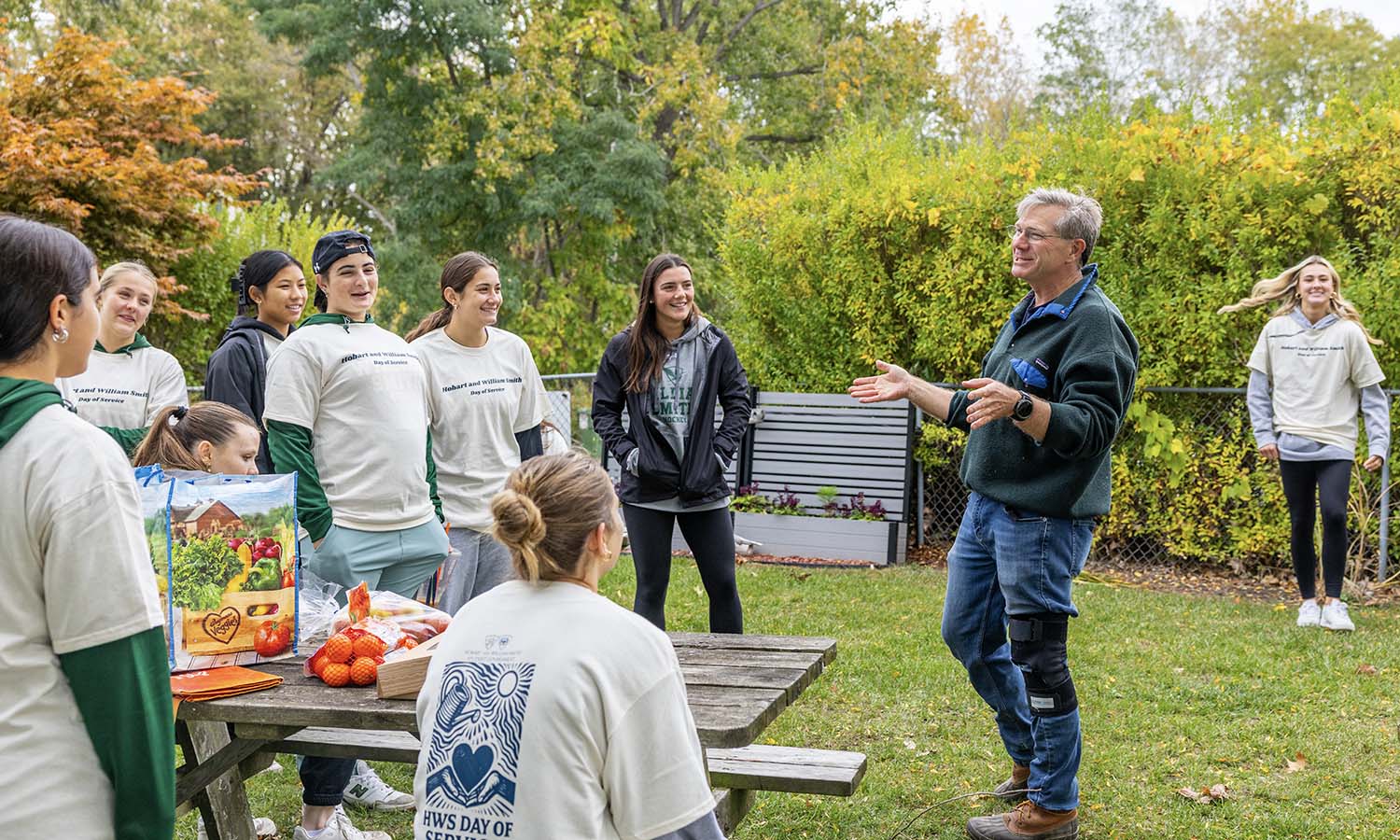 Associate Professor of Geoscience David Kendrick thanks the William Smith Ice Hockey team for cleaning up the shoreline at the Seneca Yacht Club. 