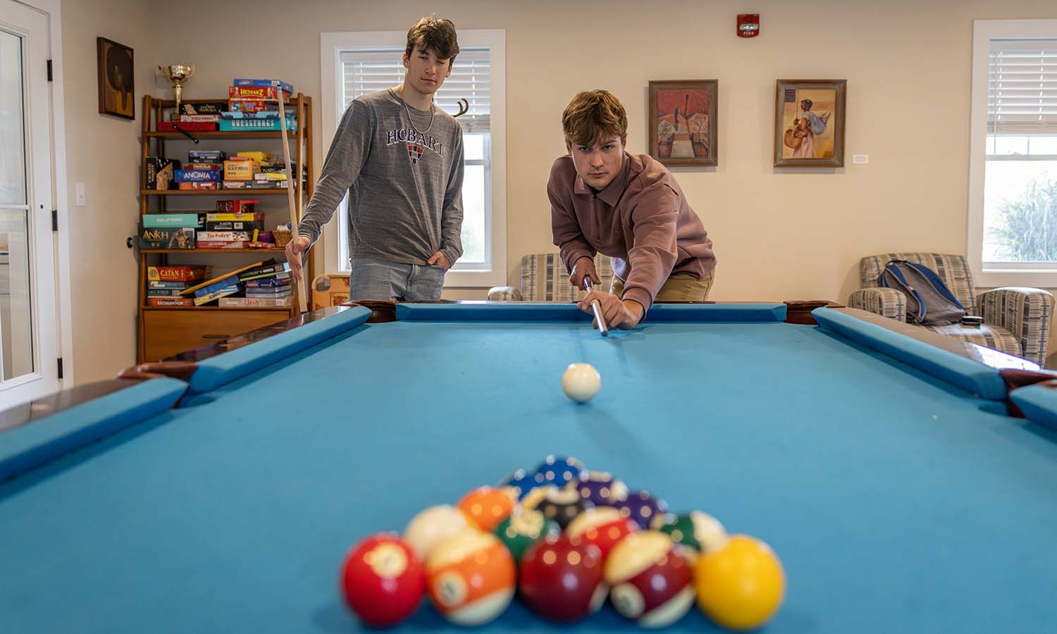 AJ Conrad ’28 and Dylan York ’28 play pool in the Adams Intercultural Center. 