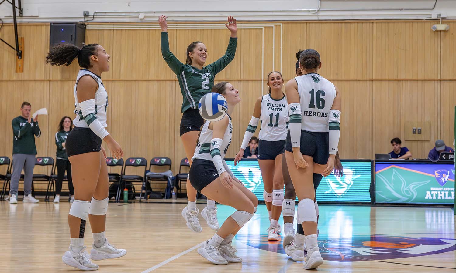 The William Smith volleyball team celebrates a block by Maren Hunt '27 in its 3-0 sweep of RIT on Wednesday. 