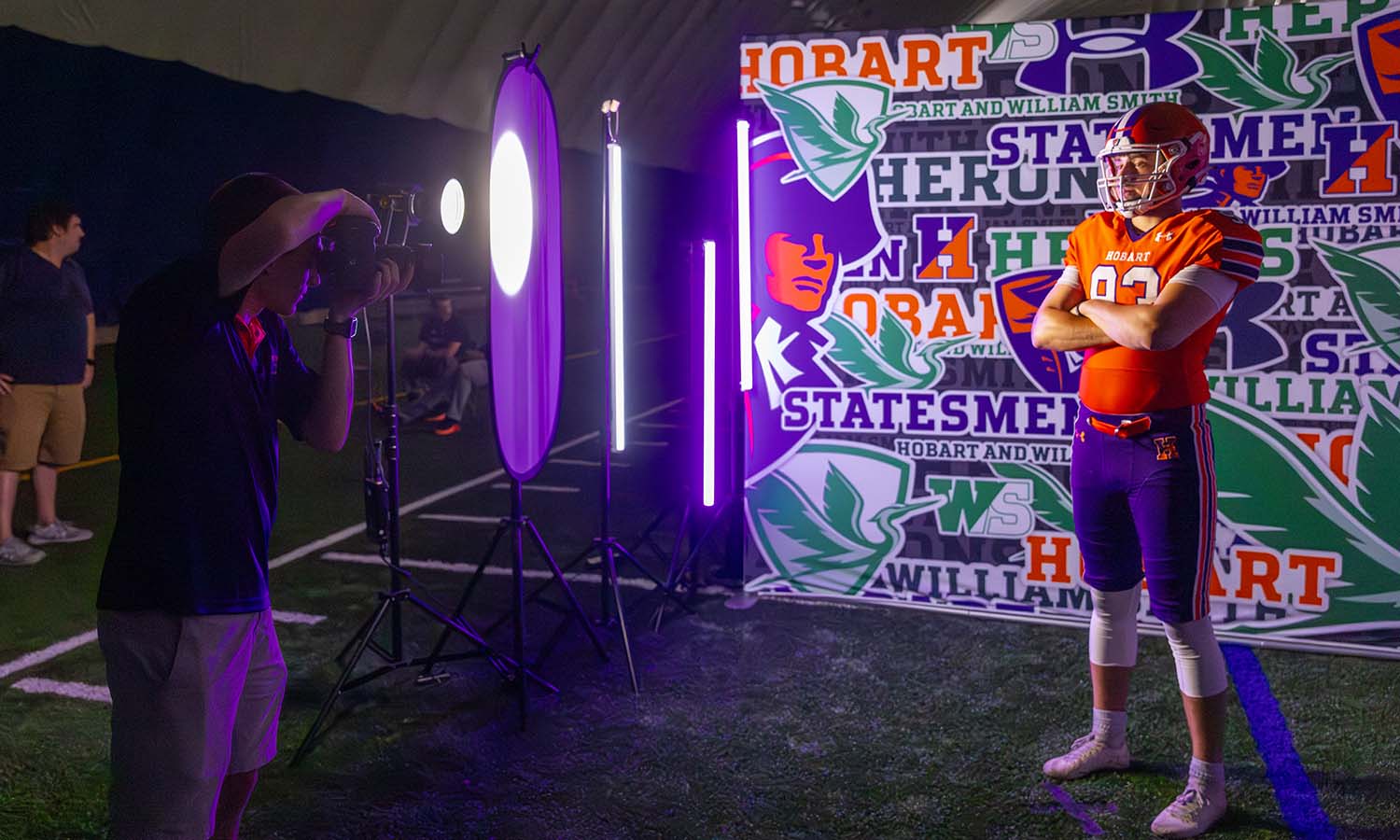 Photographer Adam Farid ’20 photographs Vicente Lyon ’27 during Hobart football’s media day in the Poole Family Dome. 