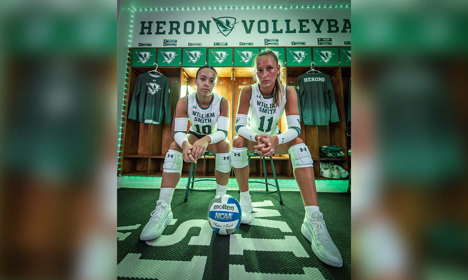 Malya Sayre ’25 and Delainy Williams ’27 pose during a William Smith volleyball photoshoot highlighting the Herons’ new jerseys for the upcoming season. The Herons open their season next Friday against Scranton. 
