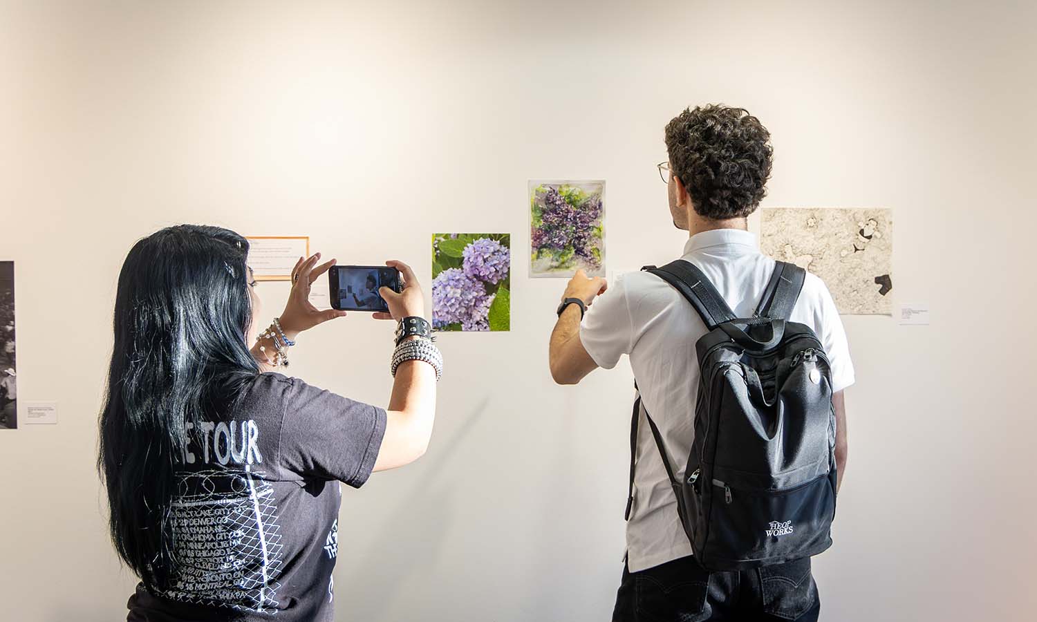 Students discuss artwork during the closing reception of “Connected from Afar” in the Provenzano Student Art Gallery. 