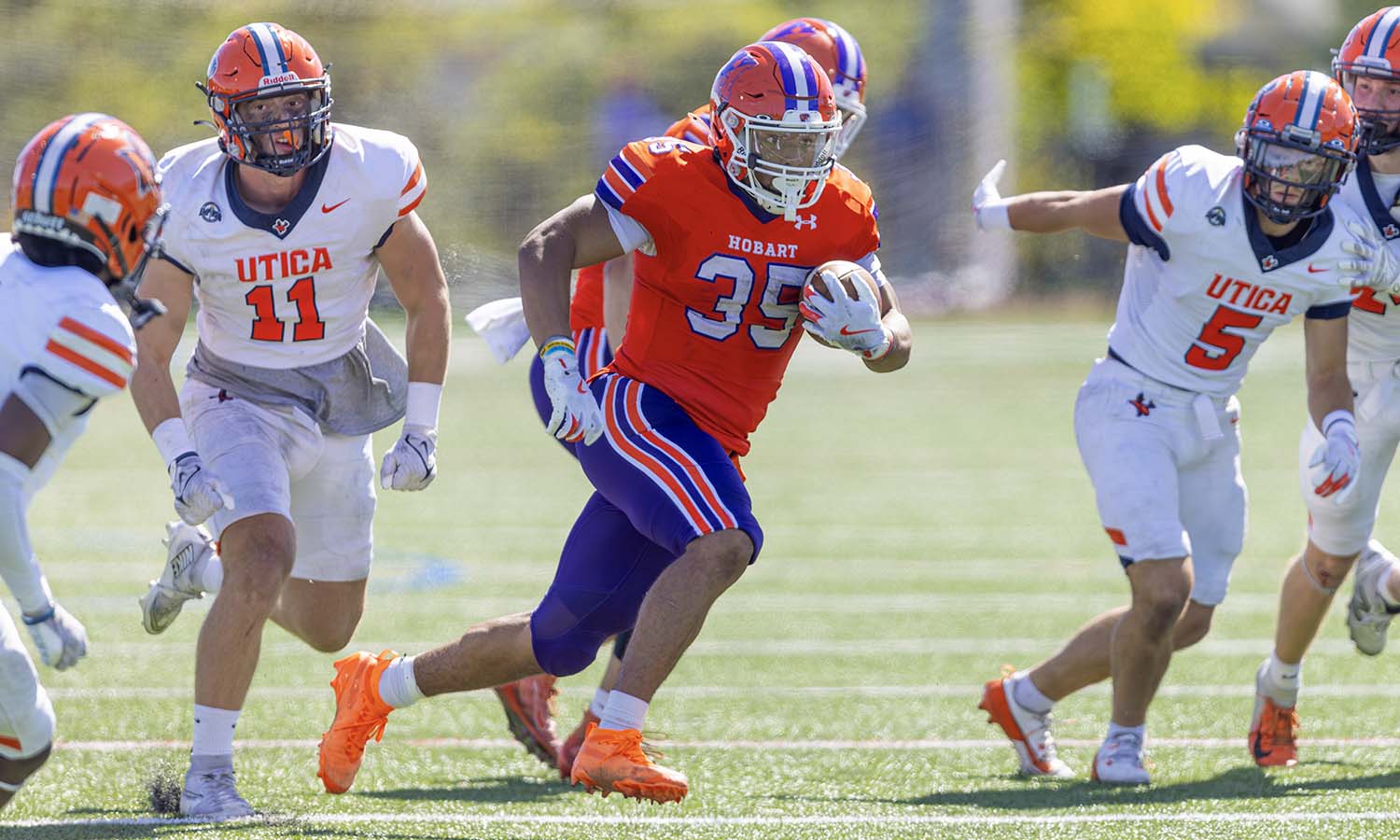 E.J. Taylor ’27 breaks through the Utica line on Saturday at Urick Stadium. He finished the game with 105 yards and three touchdowns rushing. It was his sixth 100-yard rushing game in the past seven outings and his fourth three TD game in his last five. 