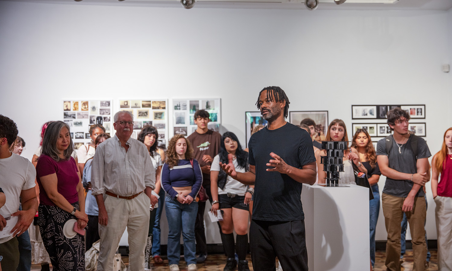 Assistant Professor of Art and Architecture Max Piersol speaks about his artwork during the opening reception of “New Point Comfort” in the Davis Gallery at Houghton House. 