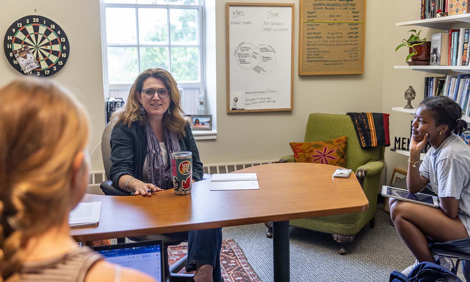 Meredith Montgomery ’27 and Chloé Woods ’27 talk with Professor of International Relations Stacey Philbrick Yadav about their research that explores the distinctions between participatory action research and engaged research in international public policy. 