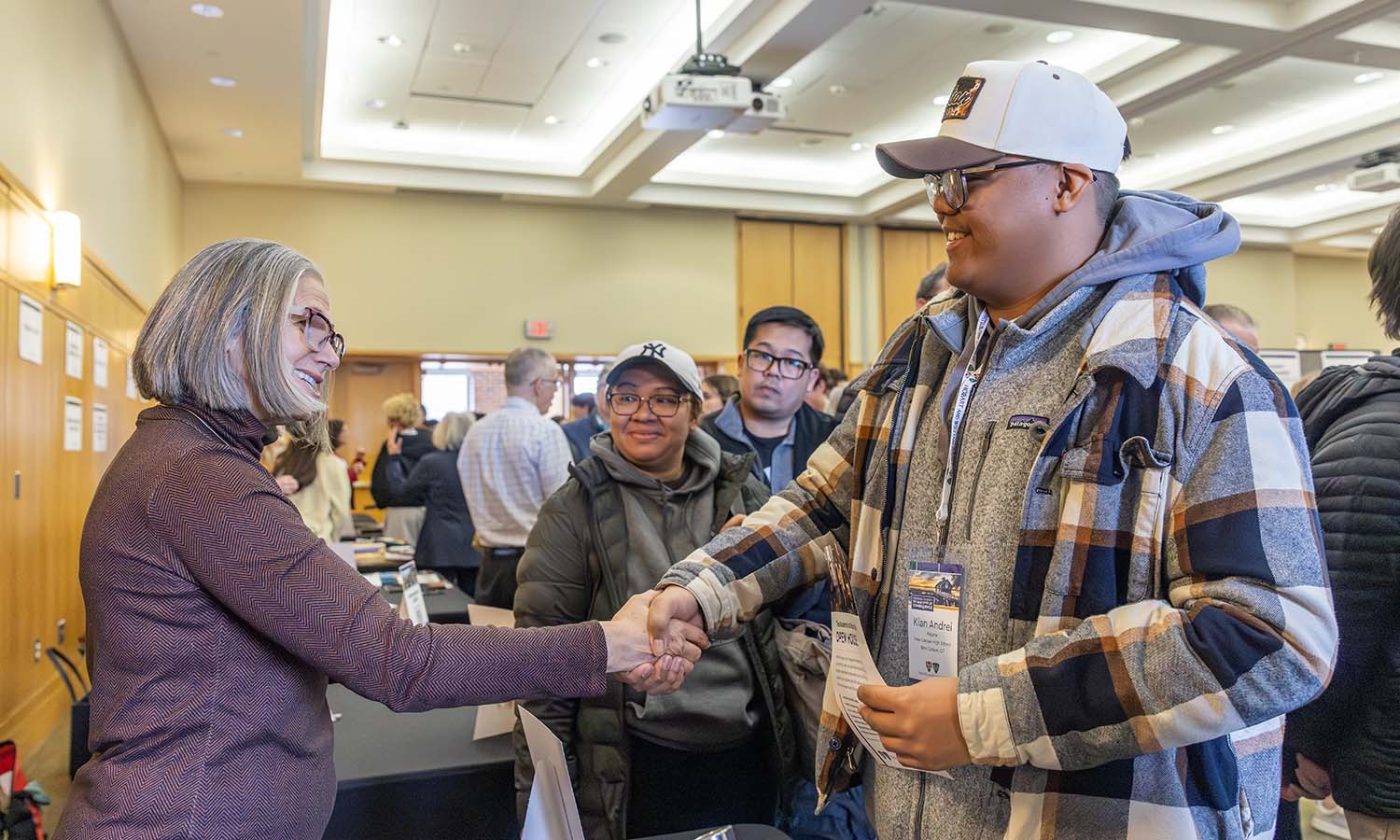 Associate Professor of Physics Ileana Dumitriu speaks to admitted students during the academic and experiential expo in Vandervort Room. 