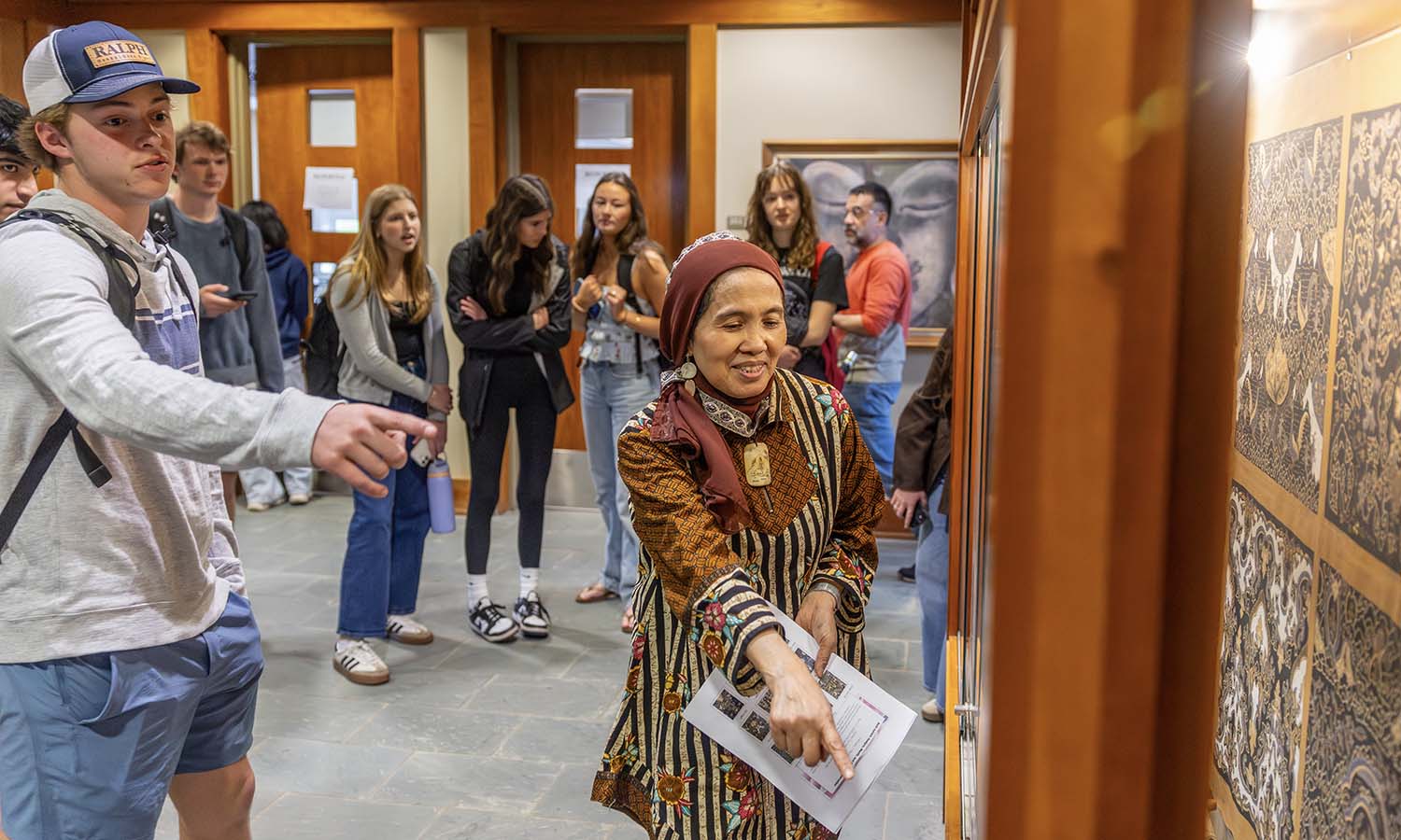 During “Sustainability, Fashion, and Justice,” Professor of Religious Studies Etin Anwar and students tour their newly installed exhibit in Stern Hall. 