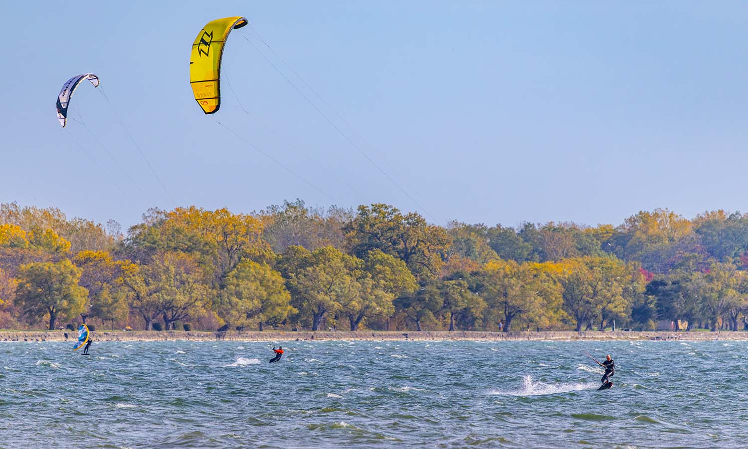 Kite surfers and wind surfers enjoy a gusty day on Seneca Lake. 