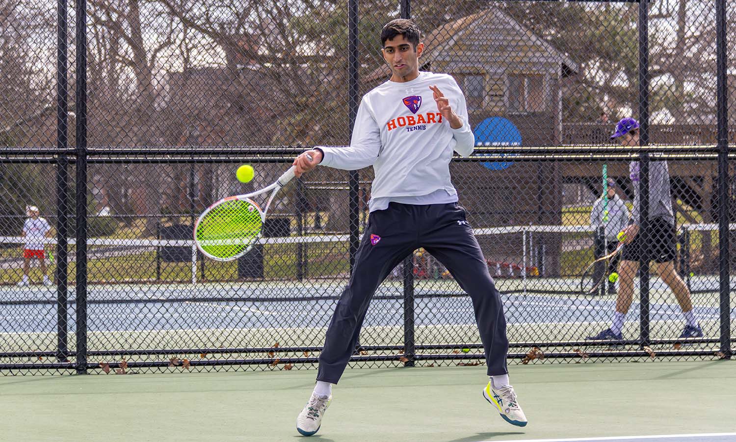 Tarang Malhotra ’26 hits a forehand shot as Hobart Tennis takes on NYU. 