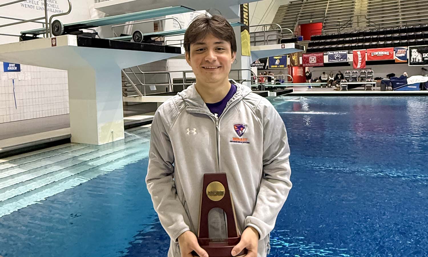 Daniel Barrientos ’26 poses with his trophy after finishing 7th in the 3m diving competition at the 2026 NCAA Division III Swimming and Diving National Championships, earning him First Team All-American status. 