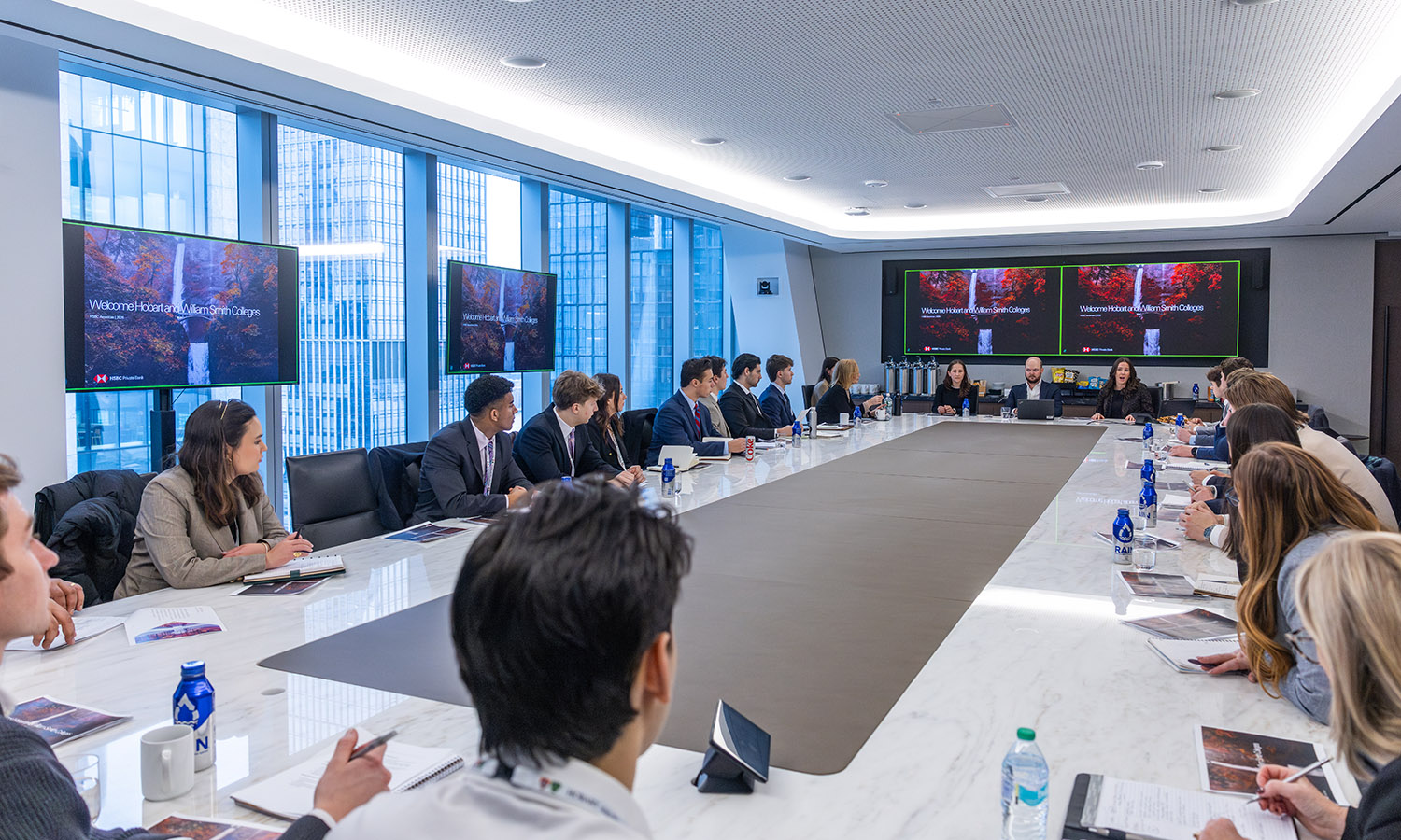 While at HSBC in New York City, Lindsay Fleischer '21, William Godfrey '16 and Jennifer Sullivan '18 discuss their careers in the financial industry with students. 