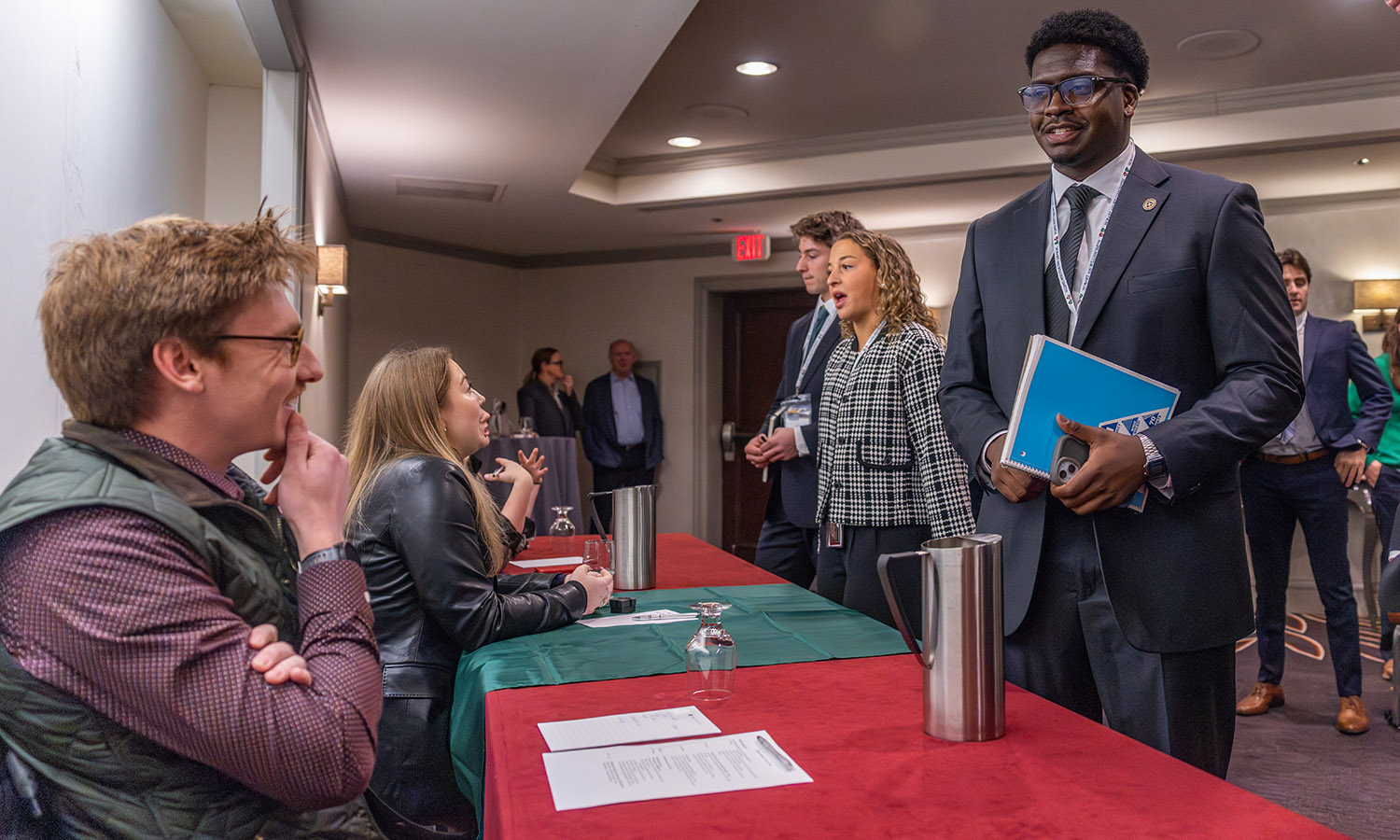 Pitch contest semifinalist David Charles '27 asks for advice from Consultant at Deloitte Matt Nusom '23. Nusom previously won the Pitch contest in 2021.  