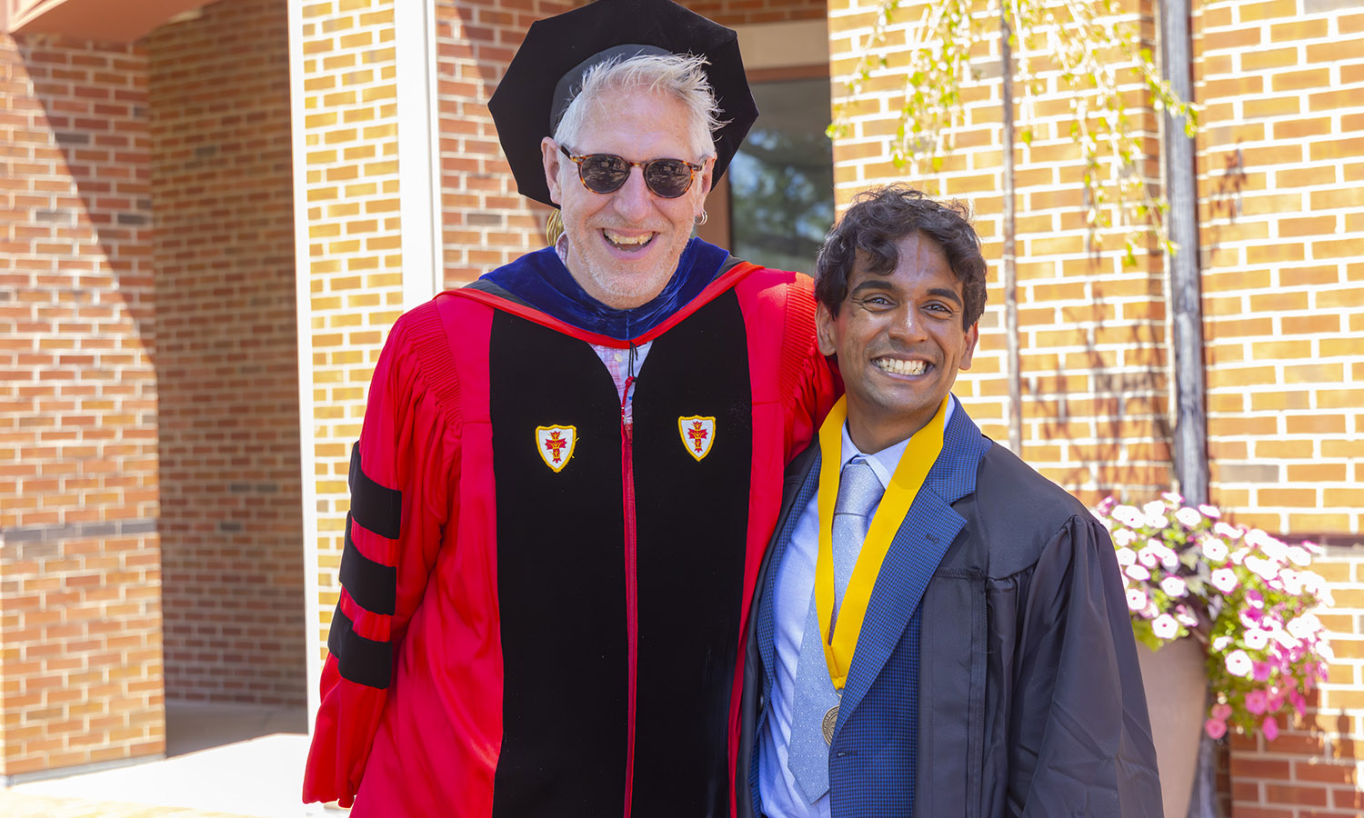 Professor of International Relations Kevin Dunn and Sandeep Tissaaratchy '26 pose for a photo after commencement.  
