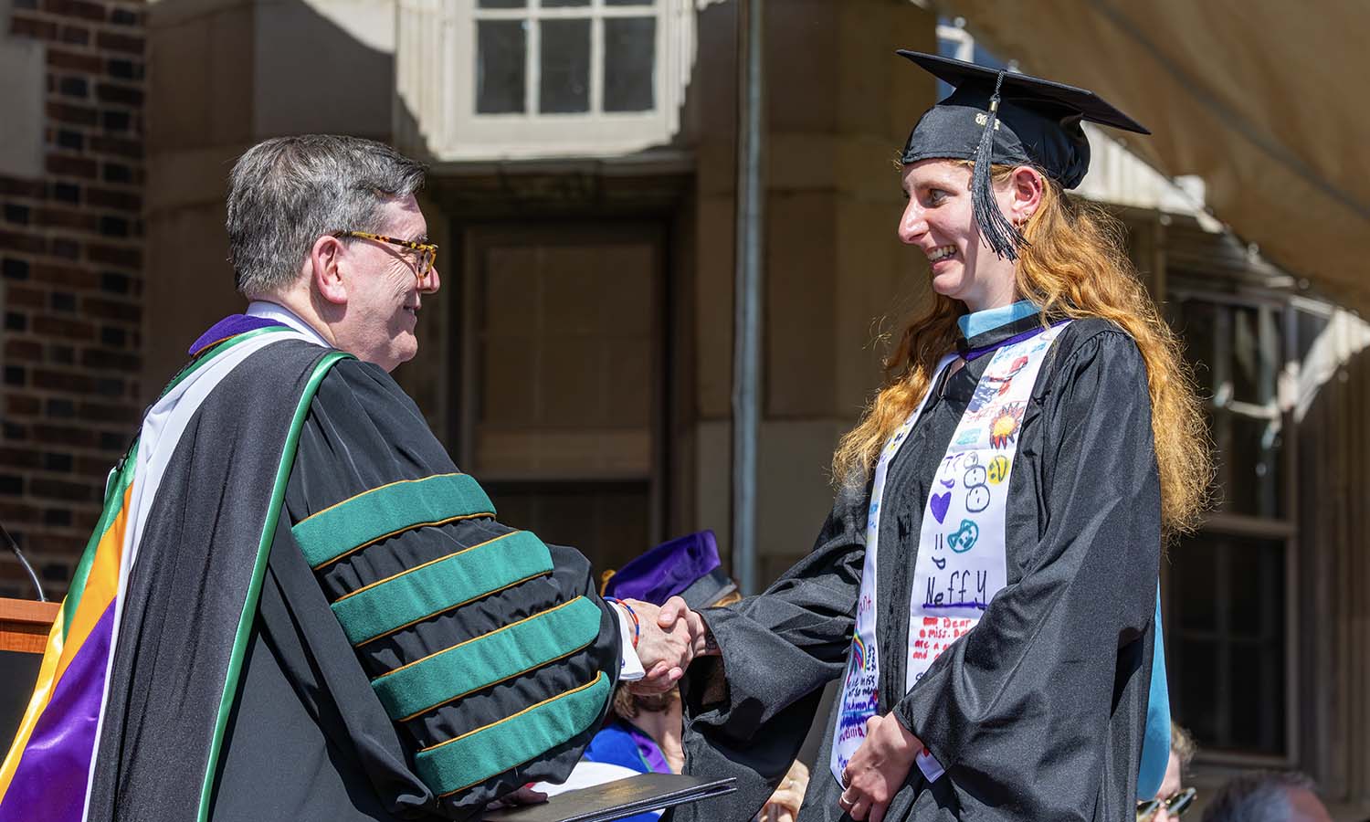 Rebecca Barr ’25, MAT ’26 receives her diploma from President Mark D. Gearan. Barr is the recipient of a 2026 U.S. Student Fulbright Award to Indonesia where she will serve as an English Teaching Assistant. 