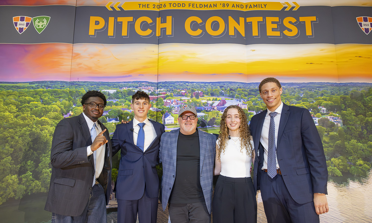 Pitch finalists David Charles II, “Duke” ’27, Nicholas Jones ’26, Virginia Ritchay ’28, and Tru Styles ’27 pose for a photo with Todd Feldman ‘89 before the announcement of the winner. 