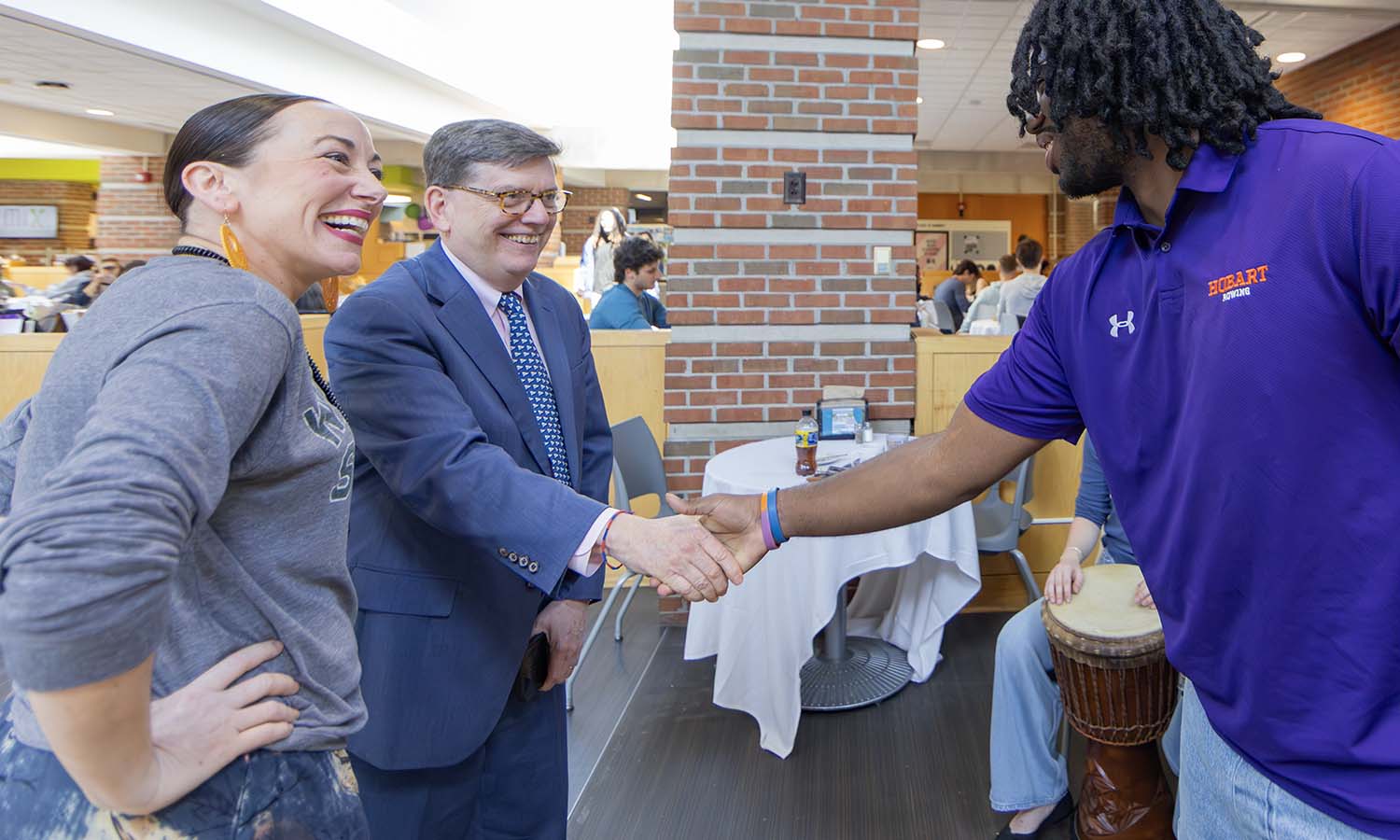 President Mark D. Gearan chats with Associate Professor of Dance and Movement Studies Kelly Johnson and RJ Roseboro ’26 before the West African Dance and Drumming event in Saga. 