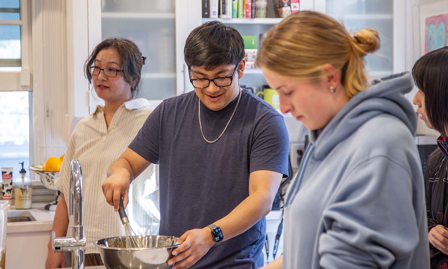 In the kitchen of the President’s House, students participate in a Japanese Cooking Demonstration with Professor of Chemistry Justin Miller. 