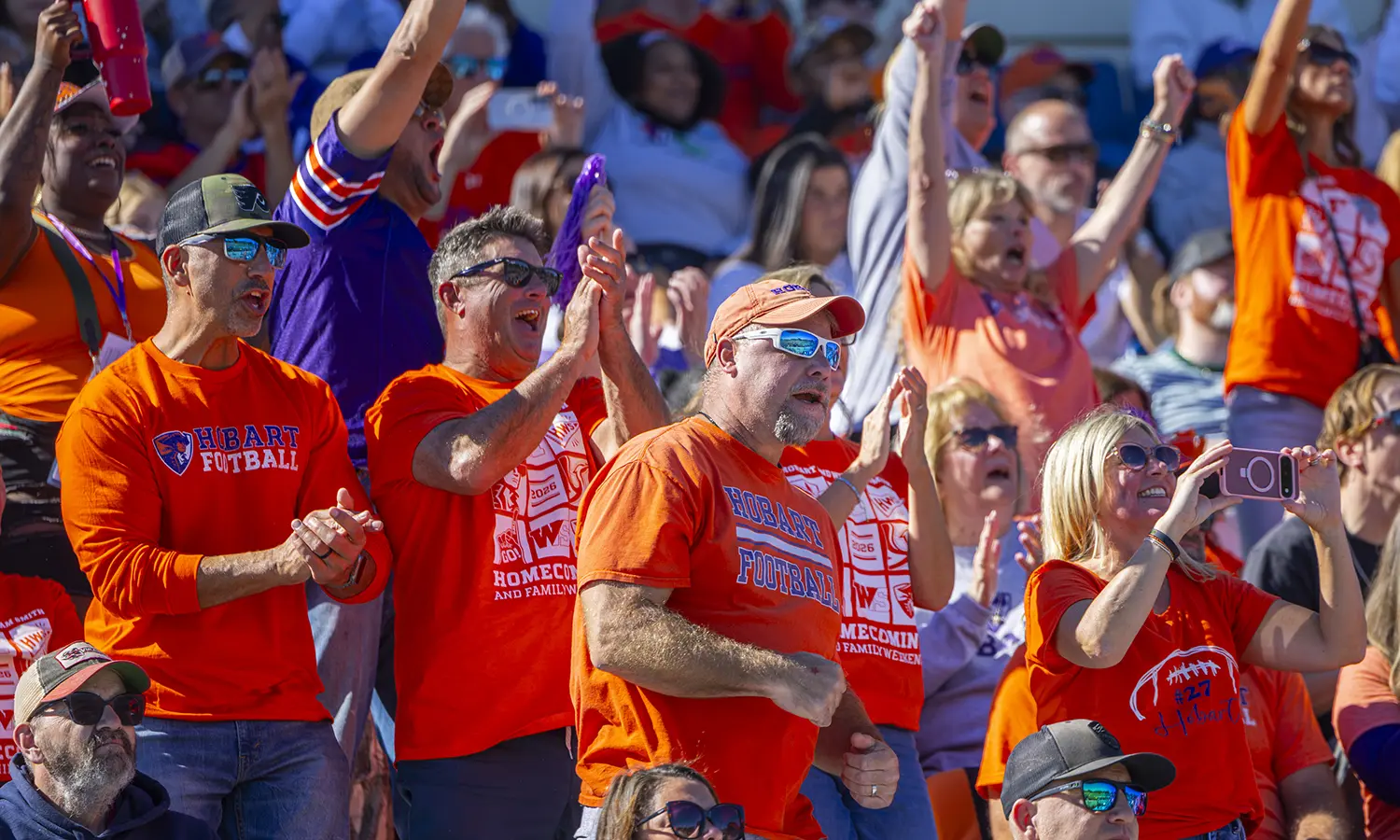 Fans cheer on the Hobart football team during the Homecoming matchup against Ithaca College. 